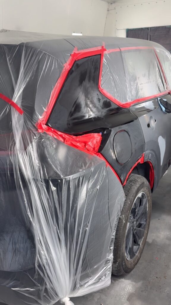 Vehicle masked and prepped for bumper paint repair in the Sindibad Auto Collision paint booth, Kennedale TX
